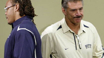Pitt defensive linemen Jabaal Sheard walks by coach Dave Waanstedt after Sheard read a statement during Pitt's media day Friday.