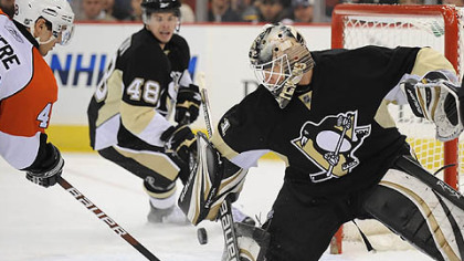 Penguins goaltender Brent Johnson makes save on the Flyers forward Daniel Briere in the second period.
