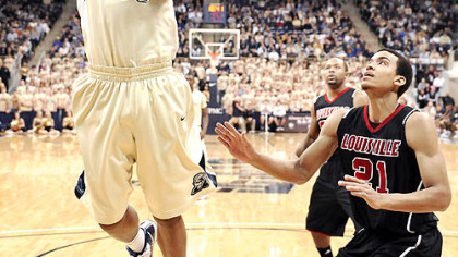 Nasir Robinson drives to the basket against Louisville's Jared Swopshire in the first half of Pitt's 82-77 victory.