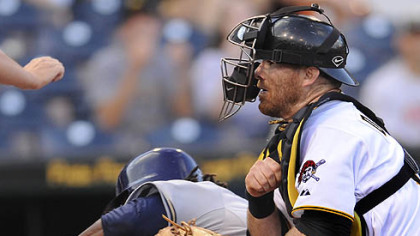 The Brewers' Rickie Weeks runs into Pirates catcher Ryan Doumit in the first inning at home plate. Weeks was safe on the play.