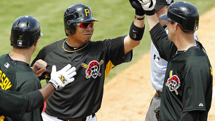 Pirates second baseman Aki Iwamura, center, is greeted by shortstop Bobby Crosby, left, and pitcher Paul Maholm, who were on base for his three-run home run in the third inning Monday.