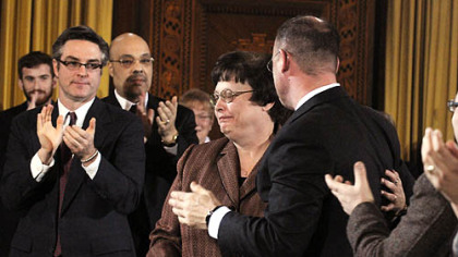 Newly elected City Council President Darlene Harris turns after hugging Councilman Bruce Kraus yesterday. To the left are Councilmen Patrick Dowd and Ricky Burgess.