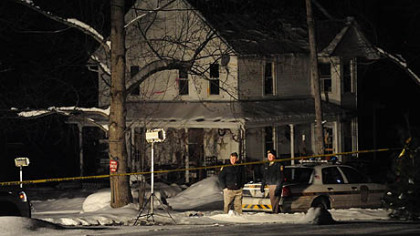 Police investigate the scene of a fatal shooting of a police officer hours after police found the suspected shooter and his wife dead in their Bredinsburg Road home yesterday.