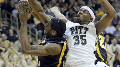 Pitt forward Nasir Robinson gets tangled up with West Virginia forward John Flowers in the first half.