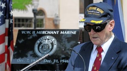 Memorial Committee chairman Nathan DeSantis reads the names of members of the U.S. Merchant Marine who were killed in the line of duty during the dedication of a monument to them Friday in Butler.