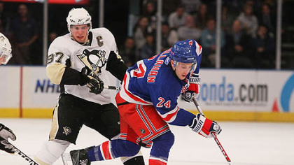 Rangers forward Ryan Callahan controls the puck in front of Penguins forward Sidney Crosby.