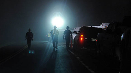 West Virginia State Police officers direct traffic in front of an entrance to Massey Energy's Upper Big Branch mine in Raleigh County after an explosion there killed at least 25 people, Monday.