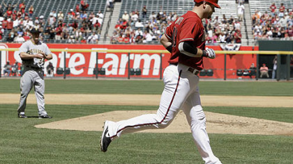 Arizona Diamondbacks' Chris Snyder, right, rounds the bases after hitting a home run against Daniel McCutchen, back left, in the second inning.