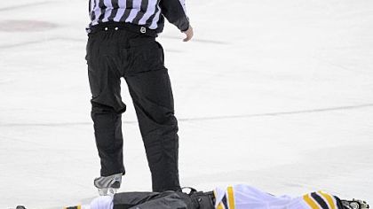 Bruins' Marc Savard lays on the ice after taking a hit by Penguins' Matt Cooke in the third period Sunday afternoon. Savard was taken off the ice on a stretcher.
