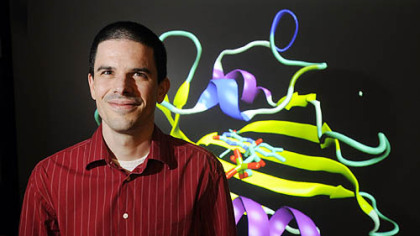 Dr. Markus Dittrich stands in front of a rendition of a photo receptor protein. The biomedical scientist at the National Resource for Biomedical Supercomputing at the Pittsburgh Supercomputing Center based in Oakland will help oversee Anton's operation.