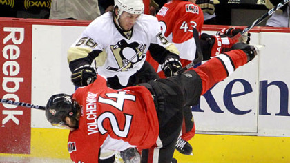 Kris Letang checks the Senators' Anton Volchenko in the first period of Game 3, Sunday in Ottawa.