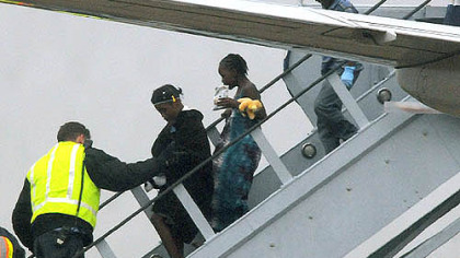 Getting a helping hand off the plane.