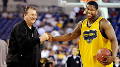 West Virginia head coach Bob Huggins talks with Danny Jennings at Lucas Oil Stadium in Indianapolis at practice yesterday in preparation for their Final Four game against Duke.