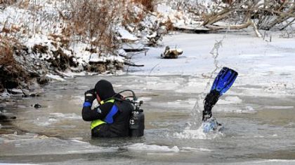 Divers search the Zelienople-Harmony Sportsmen Club's lake, looking for victims of the incident on Wednesday.
