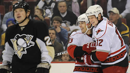 Hurricanes forwards Eric Staal, right, and Ray Whitney celebrate the a goal as Penguins forward Ruslan Fedotenko skates away during a game in December.