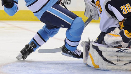 Sabres goaltender Ryan Miller trips up Penguins forward Sidney Crosby in the third period.