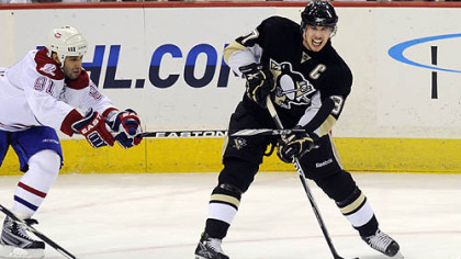 Penguins forward Sidney Crosby gets pressure from Canadiens forward Scott Gomez in the first period of Wednesday's game at Mellon Arena.