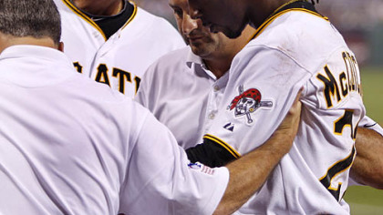 The Pirates' Andrew McCutchen is helped off the field by trainers Brad Henderson, left and Mike Sandoval, center, with manager John Russell, rear, during the second inning.