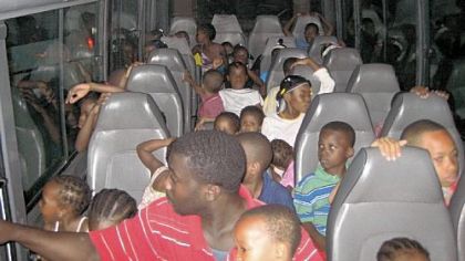 The Haitian children on the bus during their journey to the United States.