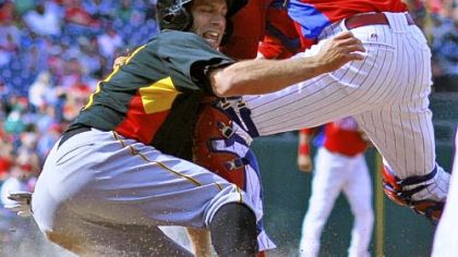 Jim Negrych, a Pitt graduate and member of Class AA Altoona, scores for the Pirates in the eighth inning Saturday, sliding past the tag of Phillies catcher Paul Hoover.