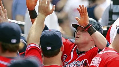 Nate McLouth celebrates in the Braves' dugout after scoring the go-ahead run on a Chipper Jones single in the eighth inning.