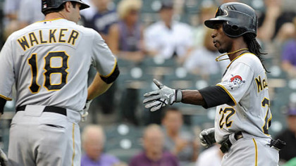 The Pirates' Neil Walker congratulates Andrew McCutchen after McCutchen scored on a single by Jose Tabata in the first inning.
