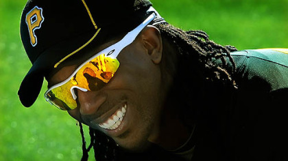 Center fielder Andrew McCutchen has a laugh during a stretch in the grass in Bradenton, Fla.