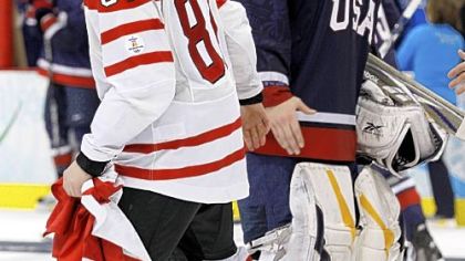 Canada's Sidney Crosby shakes hands with USA goalie Ryan Miller after the men's gold medal game Sunday at the Vancouver Olympics.