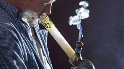 A medical-marijuana user smokes a water pipe in Portland, Maine, where the state on Friday awarded six of eight licenses to  dispensaries.