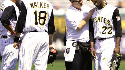 The Pirates' Andrew McCutchen has his shoulder checked by athletic trainer Brad Henderson Sunday at PNC Park.
