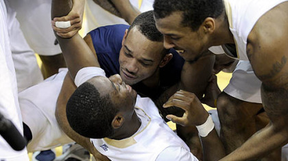 Pitt's Ashton Gibbs is mobbed by teammates after making a last-second shot to win the game.
