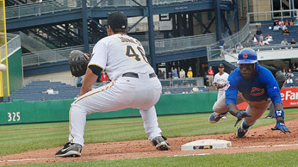 Pirates first baseman Garrett Jones waits for a throw from pitcher D.J. Carrasco in an attempt to catch Alfonso Soriano off base in the top of the sixth inning.