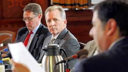 Michael Kenney, executive director of the Pittsburgh Water and Sewer Authority, listens as City Councilman Bill Peduto asks him questions about the problems with the authority's opt-out line insurance program. Earlier in the meeting, Councilman Patrick Dowd called for Mr. Kenney's resignation.