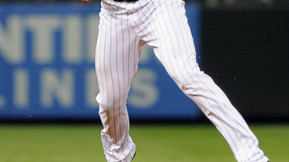 Rockies shortstop Troy Tulowitzki bobbles a ground ball hit by the Pirates' Jose Tabata in the sixth inning.