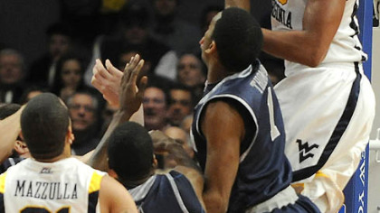 West Virginia's Wellington Smith tips the ball into the basket against Georgetown in the first half at Madison Square Garden tonight.