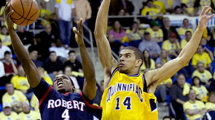 Robert Morris' Karon Abraham goes for the layup while Quinnipiac's James Feldine defends during the second half.