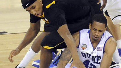 Duke's Lance Thomas grabs a loose ball in front of West Virginia's Kevin Jones in the second half of the semifinal game in the NCAA tournament in Indianapolis last night.