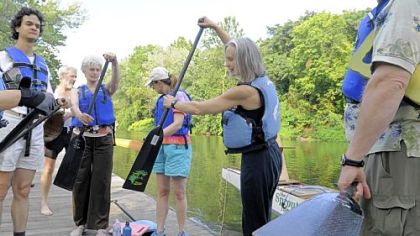 Members of a cohousing community from left, Ayres Freitas, Doug Cooper, Janet Schuster, Danelle Ardell, Stefani Danes and David Elliott practice paddling Friday at Millvale Riverfront Park.
