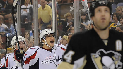 Capitals captain Alex Ovechkin, center celebrates after assisting on goal in the second period of Tuesday's game at Mellon Arena as Penguins defenseman Brooks Orpik looks away.