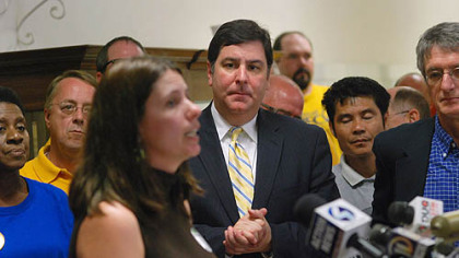 Pittsburgh City Councilman William Peduto, center, listens to one of the speakers at news conference Tuesday outside City Council Chambers about the Clean Air and Clean Water bills.