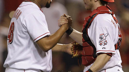 Reds relief pitcher Francisco Cordero is congratulated by catcher Ryan Hanigan after beating the Pirates.