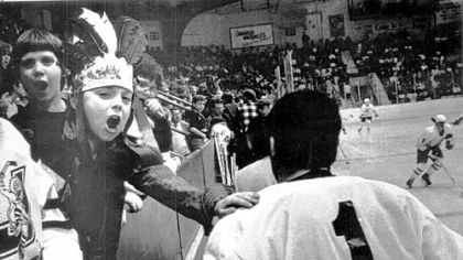 Juliette Slonka, age 7, gives Chiefs goaltender Bob Deraney a pat on the back as Deraney returns to the ice.