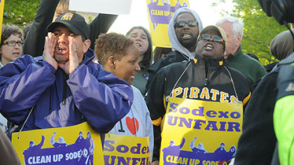 A protester yells from the middle of Forbes Avenue, in Oakland, in support of Sodexo food service workers.