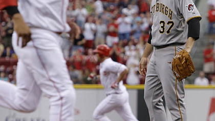 Pirates starter Charlie Morton looks on as the Reds' Scott Rolen, background, rounds the bases after a three-run home run in the first inning Thursday at Great American Ball Park.