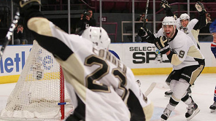 Penguins forward Chris Conner celebrates his first period goal with teammates Sidney Crosby, rear, and Pascal Dupuis during last night's game against the Rangers at Madison Square Garden in New York. The Penguins won, 4-2.