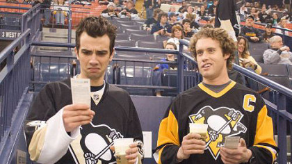 Kirk (Jay Baruchel, left) works as a TSA agent with former high school buddy Stainer (T.J. Miller, right). Here, they're seen in Mellon Arena at a Penguins game.