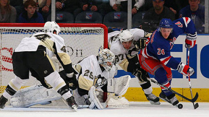 Penguins goaltender Marc-Andre Fleury and forward Sidney Crosby defend the net against Rangers forward Ryan Callahan.