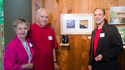 Annie, left, Gene and Tim Burak stand next to the collaborative photographic piece that Gene and Tim created for the Associated Artists of Pittsburgh at Fallingwater exhibition.