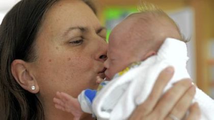Pediatric nurse Judy Ruane enjoys some hands-on time with 1-month-old Tiernan Ruddy during her duties at The Children's Home.