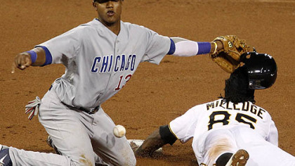 The Pirates' Lastings Milledge steals second base in the eighth inning as the ball gets away from Cubs shortstop Starlin Castro.